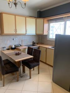a kitchen with a table and chairs and a refrigerator at chris house in Kalamata