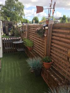 a fence with potted plants and a table at The Corner House in Halesworth