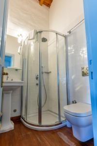 a bathroom with a shower with a toilet and a sink at Alaçatı Taş Otel in Alaçatı
