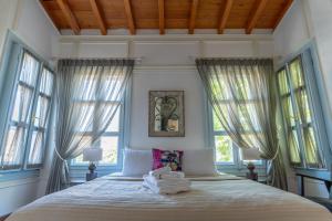 a bedroom with a bed with towels on it at Alaçatı Taş Otel in Alacati