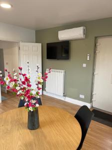 a vase of flowers on a table in a room at Peacock Farms Estate in Cork