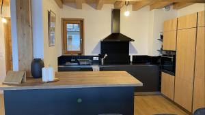 a kitchen with a black counter and a stove at Chalet La Mahure in Fontcouverte
