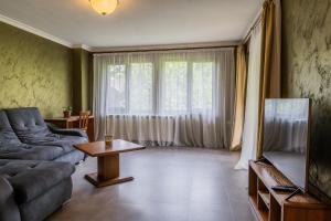 a living room with a couch and a tv at Guest House Valevtsi in Valevtsi