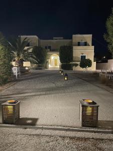 a street at night with a house in the background at Giosifaki in Vári