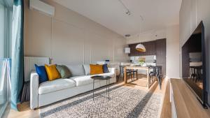 a living room with a couch and a dining room at Porta Mare Marina, Sun & Snow in Dziwnów