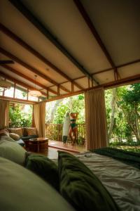a couple of people standing in a room with a surfboard at Grün Resort Uluwatu in Uluwatu