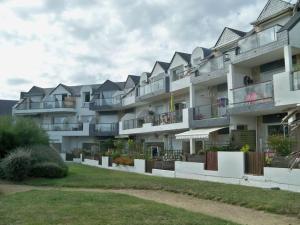 een groot appartementencomplex met balkons en een tuin bij RÉF 323 LARMOR PLAGE 18 rue Beg Tal Men in Larmor-Plage