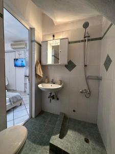 a bathroom with a sink and a shower at Valente Rooms Kythira in Kythira