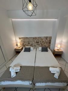 a bedroom with a large bed with towels on it at Valente Rooms Kythira in Kythira