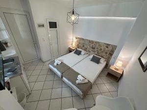 a small bedroom with a bed and a bathroom at Valente Rooms Kythira in Kythira