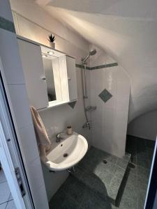 a small bathroom with a sink and a mirror at Valente Rooms Kythira in Kythira