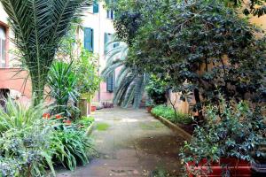 a garden with trees and plants and a building at Karol Apartment Rome in Rome