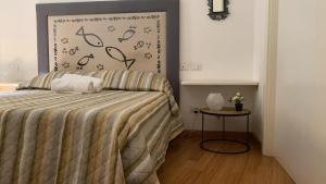 a bedroom with a bed and a side table at Karol Apartment Rome in Rome
