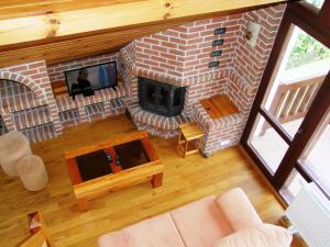 an overhead view of a living room with a brick fireplace at Panorama Mikołajki Mazurski-zakątek in Mikołajki