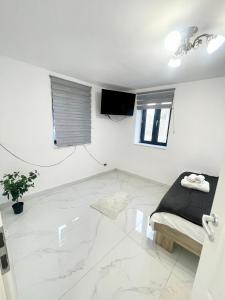 a living room with white walls and a marble floor at Apollo 1 Apartment in Bucharest