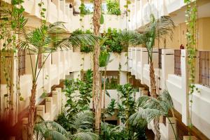 a staircase with plants and trees in a building at Iberostar Selection Marbella Coral Beach in Marbella