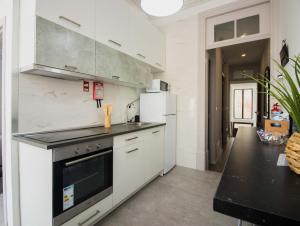 a kitchen with white appliances and a black counter top at Casa das Vigas II in São Mamede de Infesta