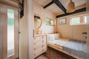 a small bedroom with a bed and a mirror at HOUSEBOAT FRED Prague in Prague