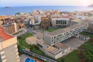 an aerial view of a city with buildings and the ocean at Apartamentos La Era Park in Benidorm