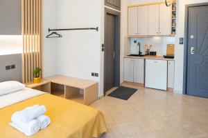 a bedroom with a yellow bed and a kitchen at Stylish Apartment in Xanthi - Meno Homes 5 in Xanthi