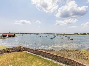 a large body of water with boats in it at Pass the Keys Historic Waterfront Home in Bosham in Bosham