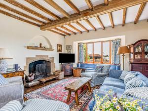 a living room with couches and a fireplace at Pass the Keys Historic Waterfront Home in Bosham in Bosham