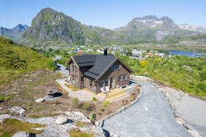 an aerial view of a house on a mountain at The Magic View - Nature and Sea in Sørvågen