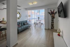 a living room with a giraffe head on the wall at Apartamento Sofia en CALPE in Calpe