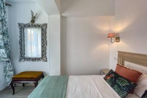 a bedroom with a bed and a mirror and a chair at Apartamento Sofia en CALPE in Calpe