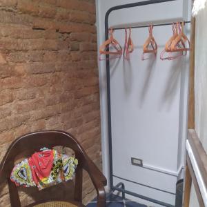 a refrigerator with pairs of shoes hanging on a rack at Studio SUITE M&J in Caracas