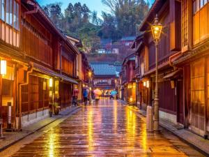 a wet street in an old town at night at ダイアパレス大手門 in Kanazawa +205 photos