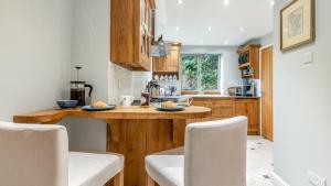 a kitchen with wooden cabinets and a counter top at Hawkfield in Baslow