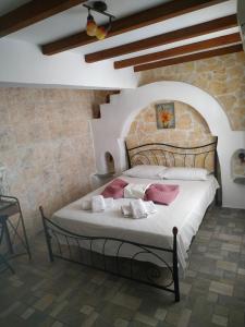 a bedroom with a bed in a stone wall at Lucas B Panorama in Alopronia