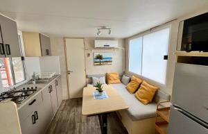 a small kitchen with a table in a caravan at Mobilehome Adams Glamping - Camp Adriatic in Primošten