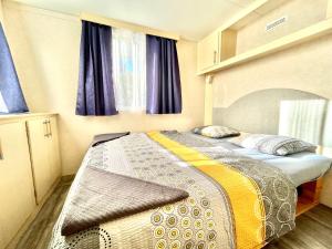 a bedroom with two beds in a room at Mobilehome Adams Glamping - Camp Adriatic in Primošten