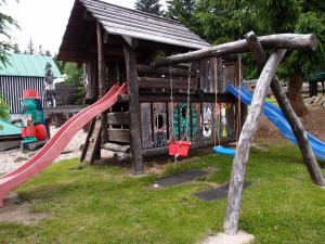 a playground with a slide and swings at Chata Mísečky in Horni Misecky