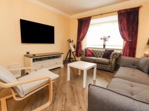 a living room with a couch and a tv at 23 Wolsey Close in Thornton