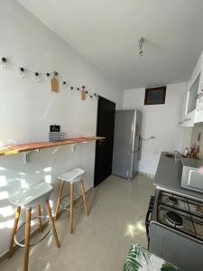 a kitchen with a counter and a refrigerator at Pinky studio in Dobroeşti