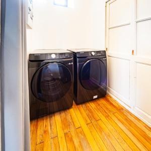 two washing machines are sitting in a laundry room at Jolie m'Home*Le Puy du Fou in Mauléon