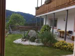 a backyard with a bench and a rock garden at Panorama Residence Schlossblick in Rodengo