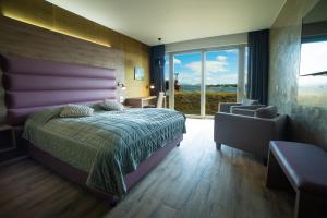 Postel nebo postele na pokoji v ubytování Hotel Kriunes
