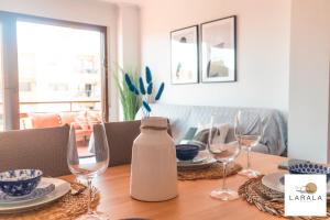 een eettafel met glazen en een kruik erop bij Larala 03 - Nuevo apartamento frente al mar en el Arenal en Jávea in Jávea
