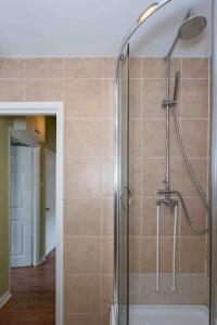 a shower with a glass door in a bathroom at Camden Apartment By Morethanstays in London