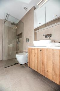 a bathroom with a sink and a shower and a toilet at LASARI comfort living in Thessaloniki