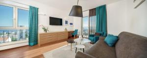 a living room with a couch and a table with a tv at Dioklecijan Hotel & Residence in Split