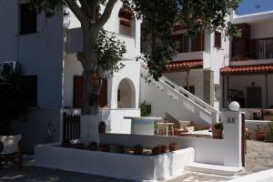 a white building with stairs and potted plants at Aristidis in Galissas