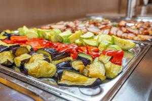a tray of different types of vegetables on a buffet at Mera Holiday Resort in Venus +55 photos