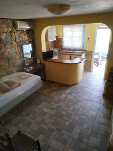 a kitchen with a tub and a sink in a room at Lucas B Panorama in Alopronia