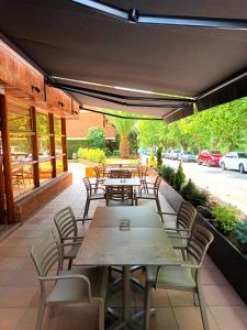 a group of tables and chairs on a patio at Hotel Estel in Berga