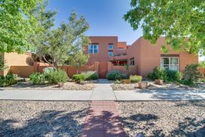 a home in the desert with trees and a sidewalk at Pet-Friendly Albuquerque Vacation Escape! in Albuquerque